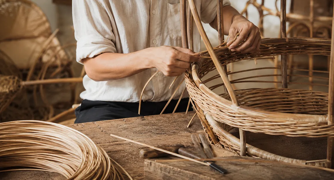 Artisan weaving rattan basket